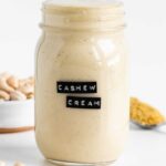 vegan cashew cream sauce inside a glass mason jar with a black label