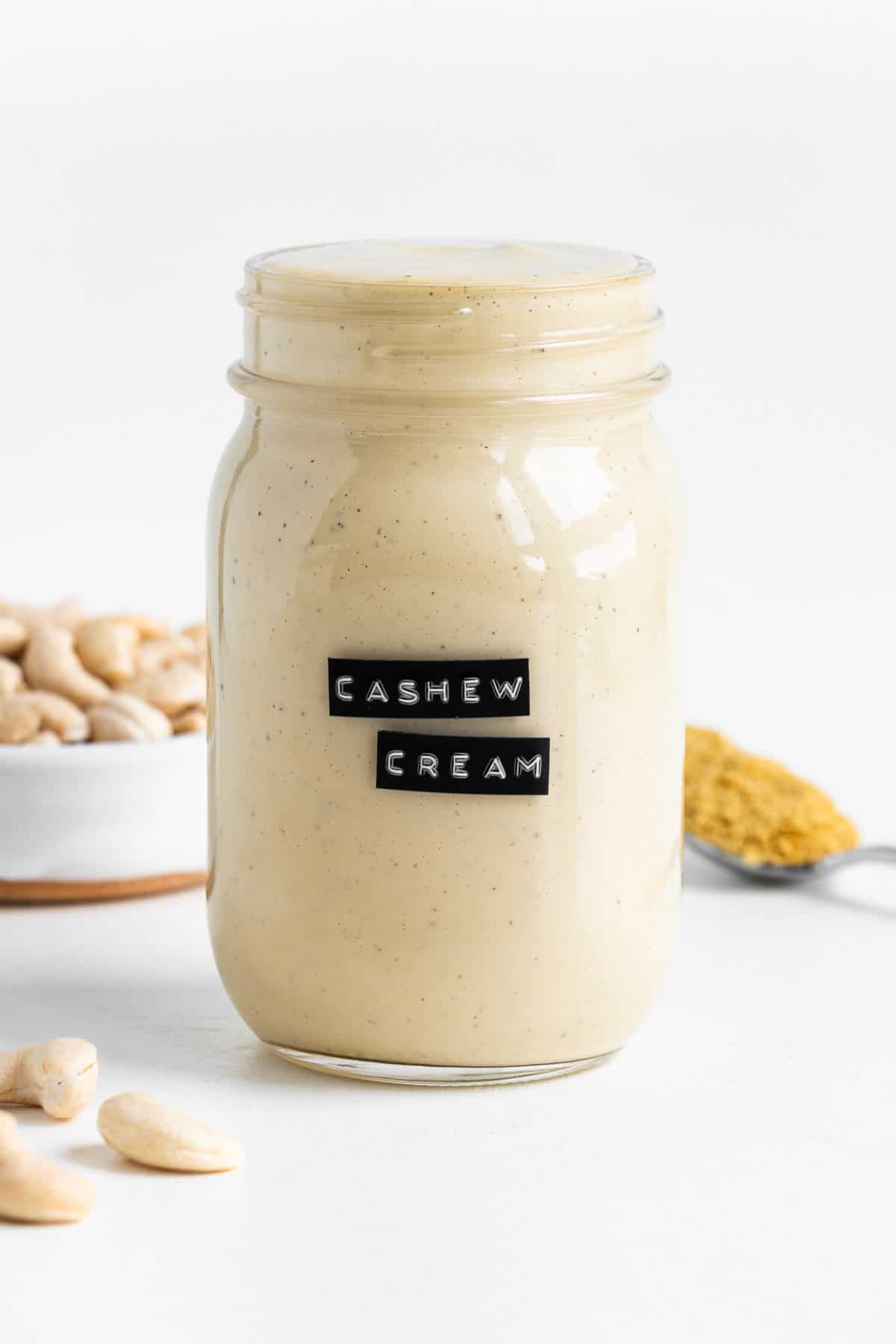 vegan cashew cream sauce inside a glass mason jar with a black label