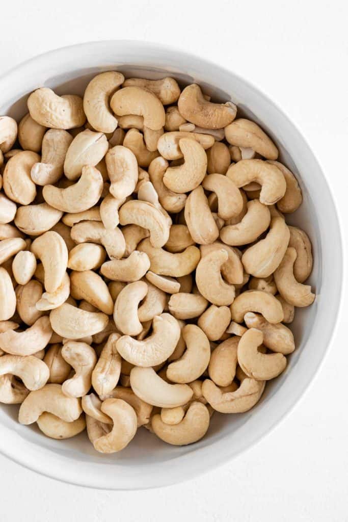 raw cashews inside a white bowl