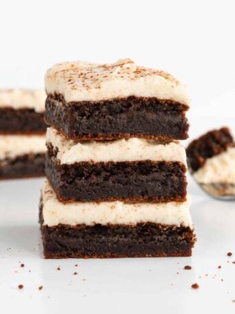 a stack of three vegan frosted gingerbread cookie bars