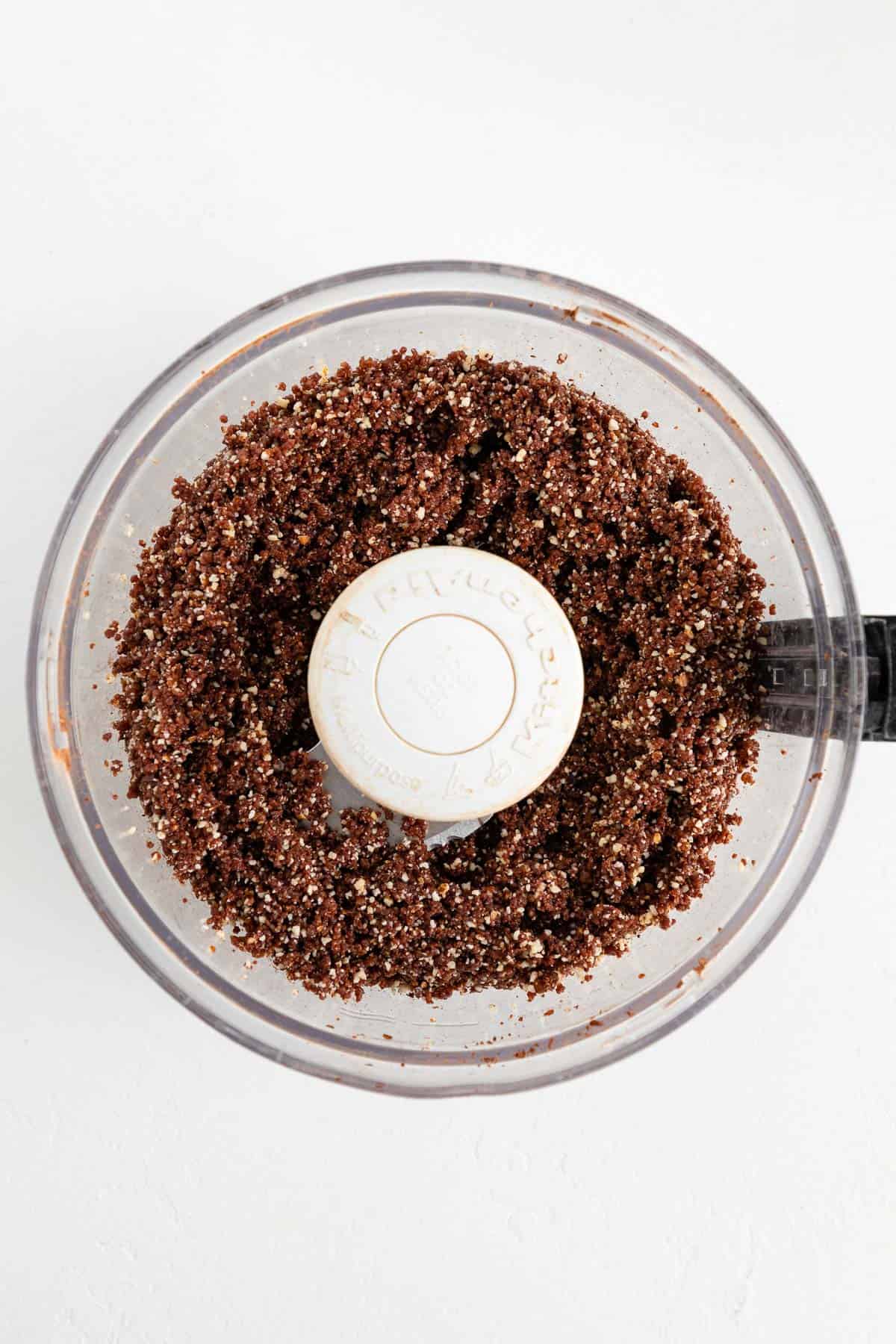 medjool dates, almonds, walnuts, and cocoa powder combined in a food processor