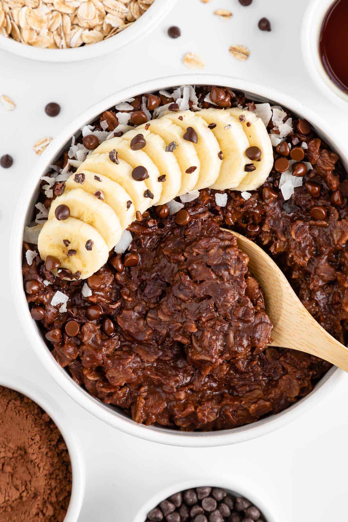 a wooden spoon scooping into a bowl of chocolate oatmeal