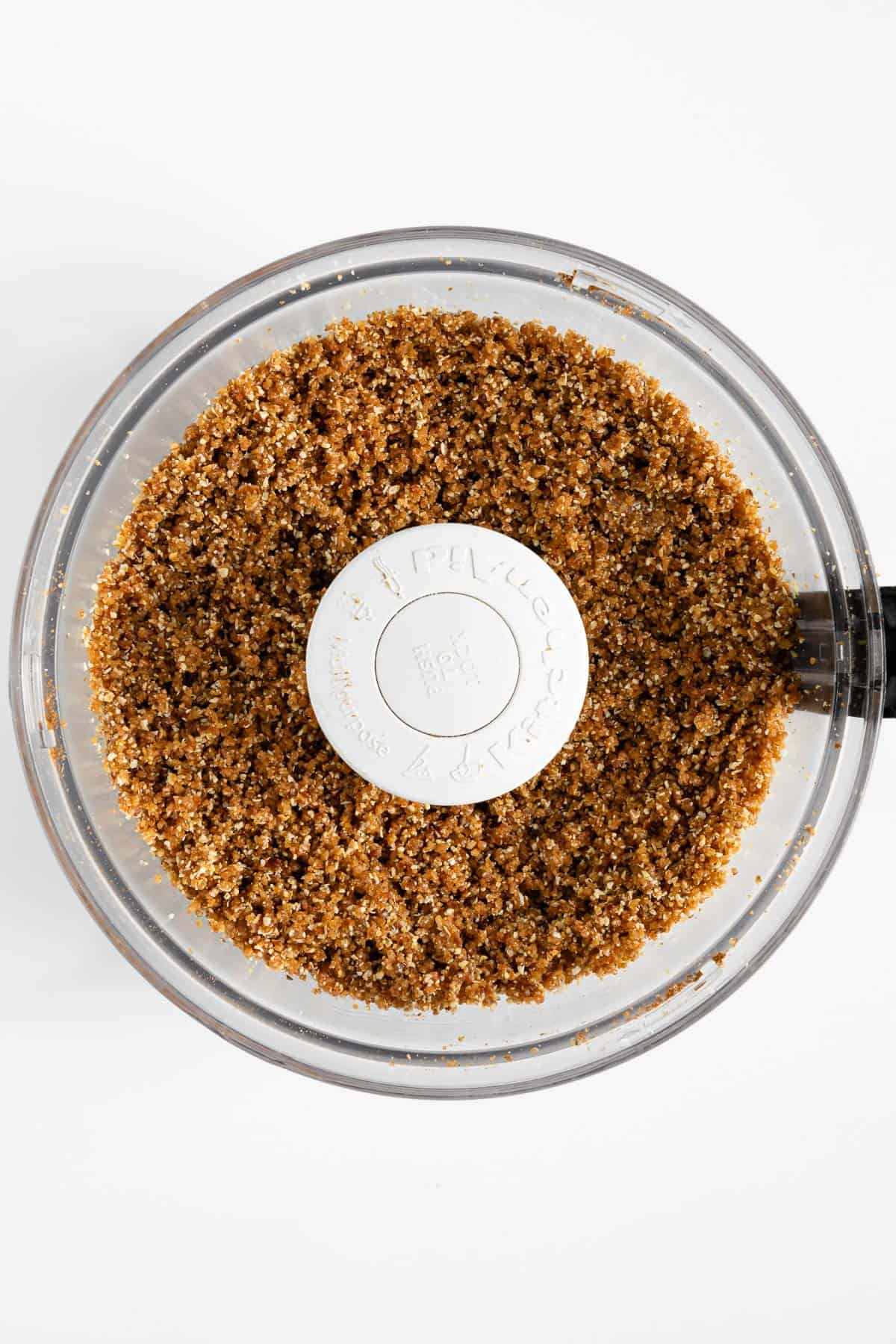 blended date and nut mixture inside the bowl of a food processor