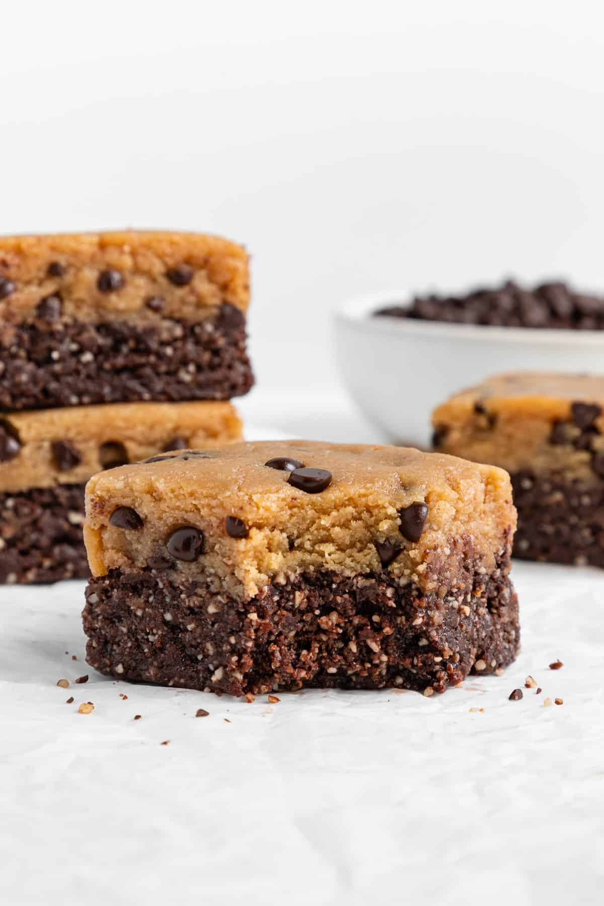 a no bake cookie dough brownie with a bite taken out of it, surrounded by more brownies