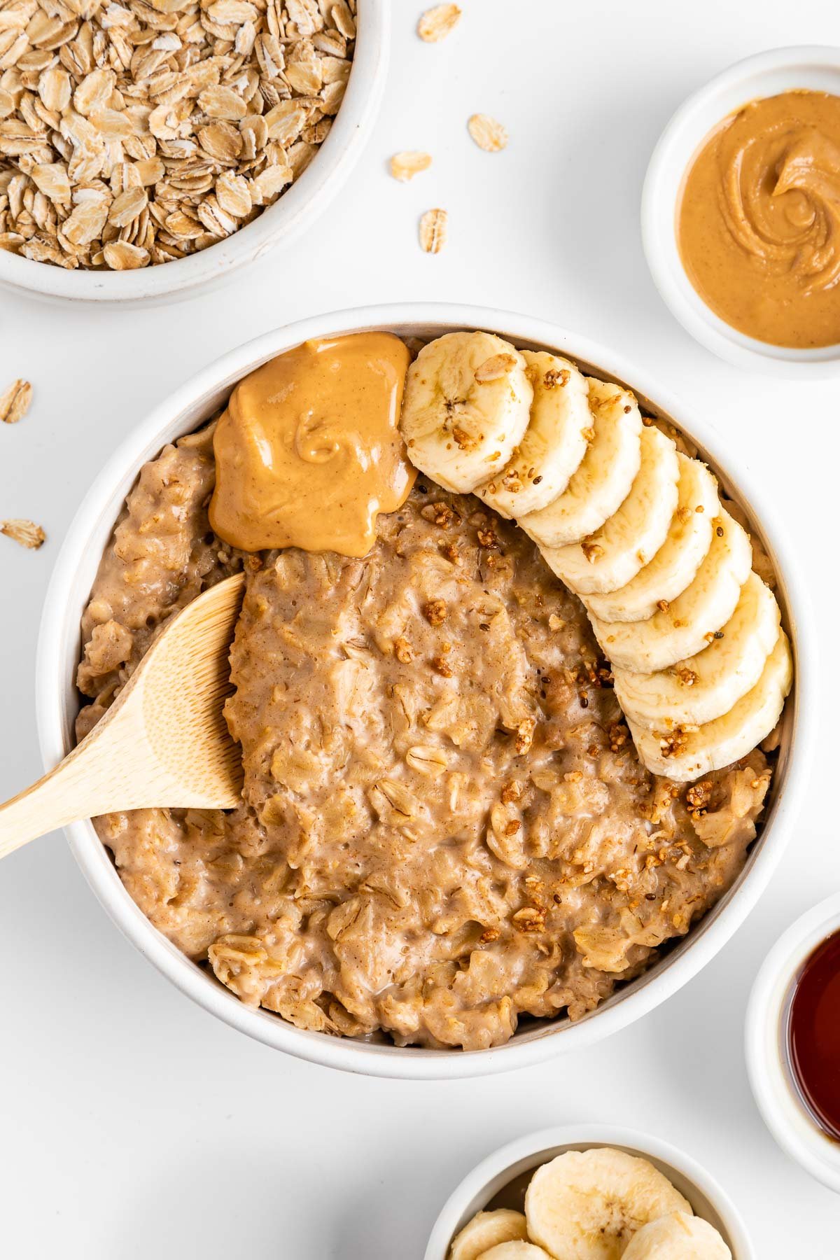 a wooden spoon scooping peanut butter oatmeal out of a bowl