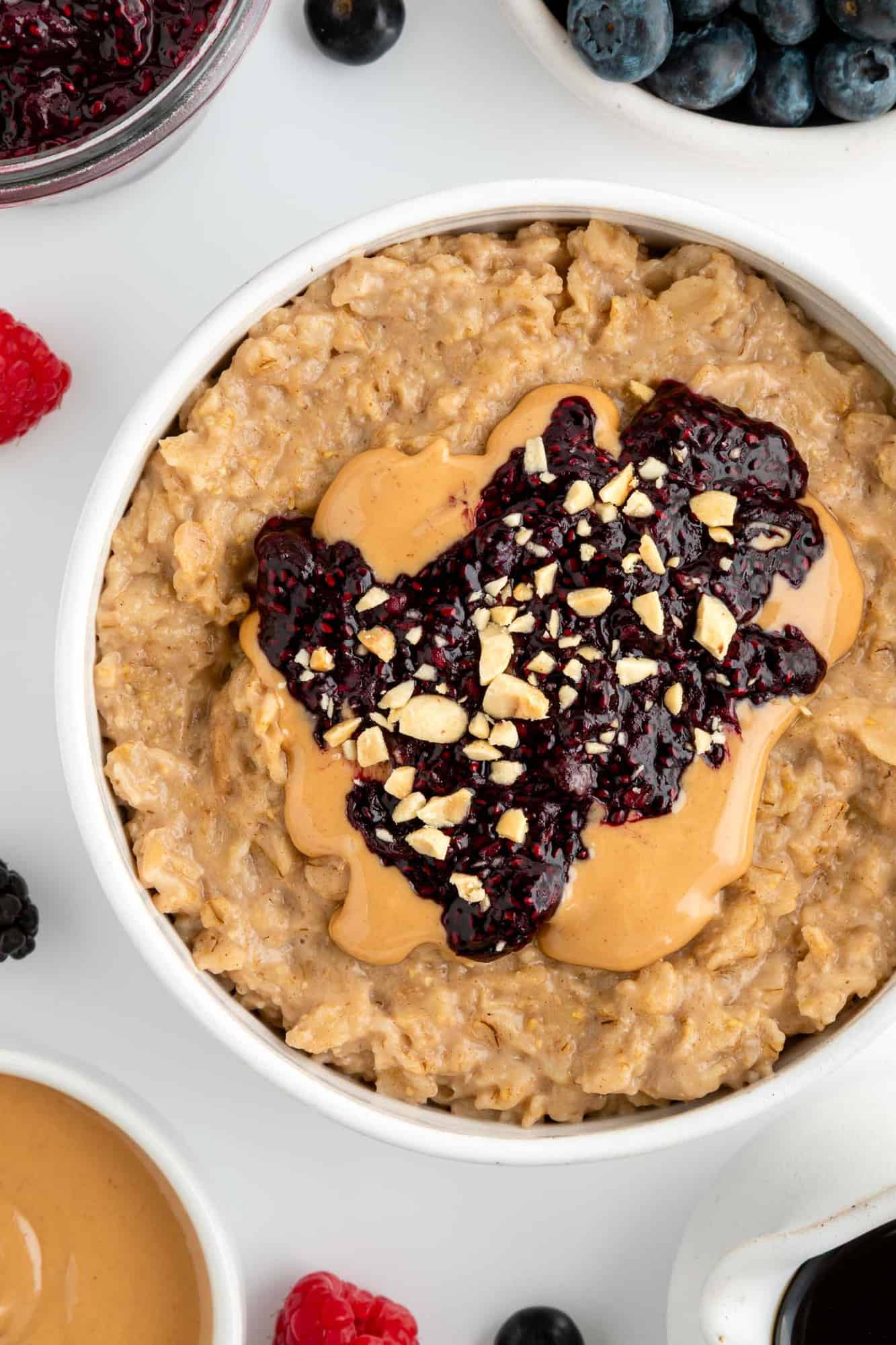 close up image of peanut butter and jelly oatmeal inside a white bowl