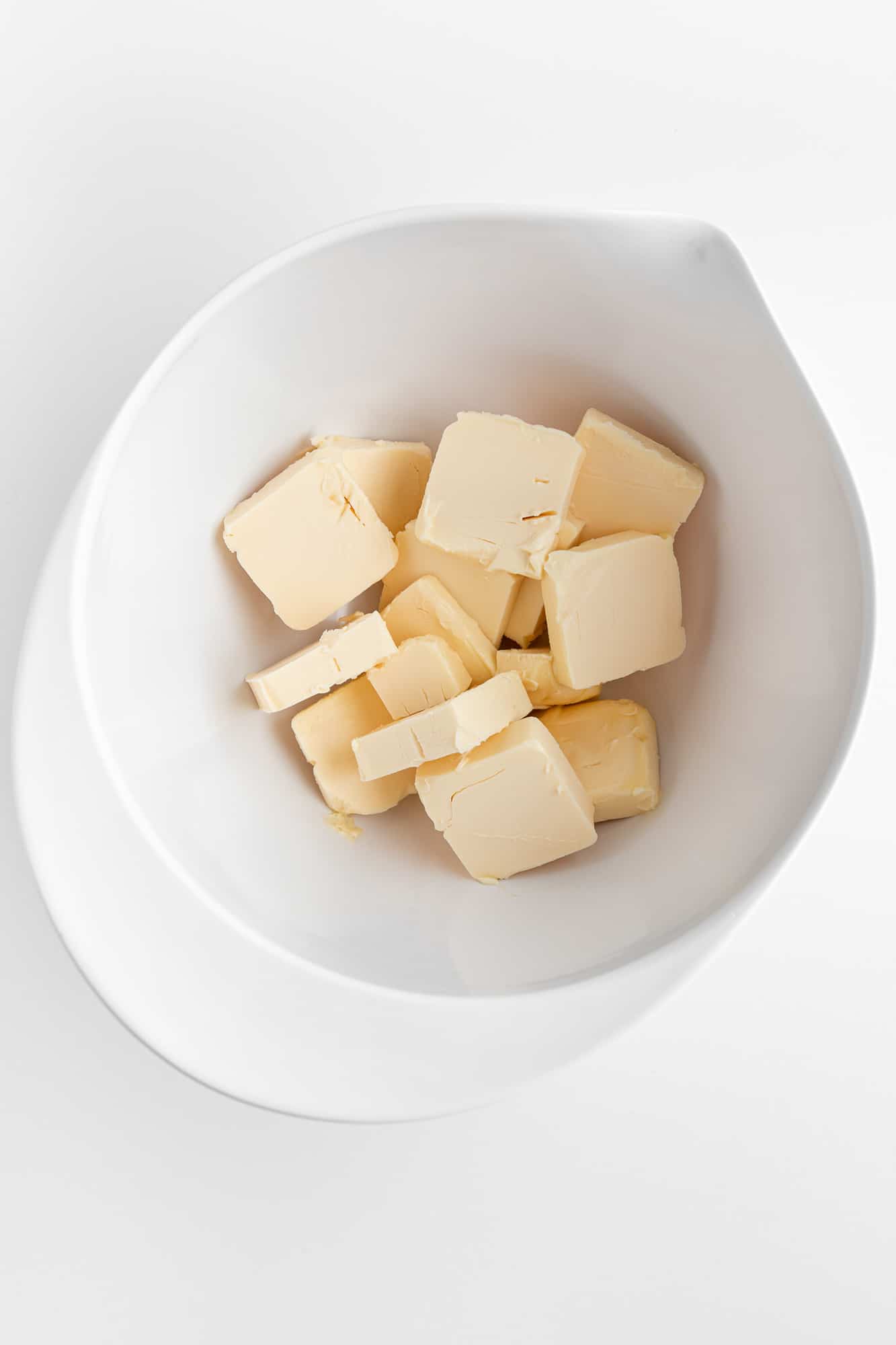 cubed butter in a large white bowl