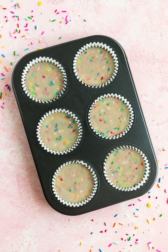 vegan funfetti cupcake batter inside a 6 slot cupcake tin