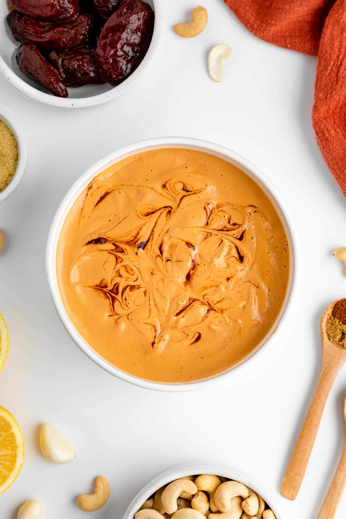 vegan chipotle aioli in a white bowl surrounded by ingredients