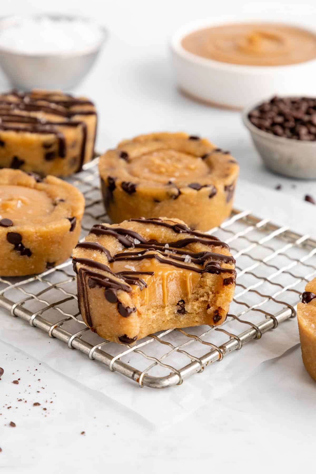 no bake caramel cookie dough cups with a bite taken out of the middle one
