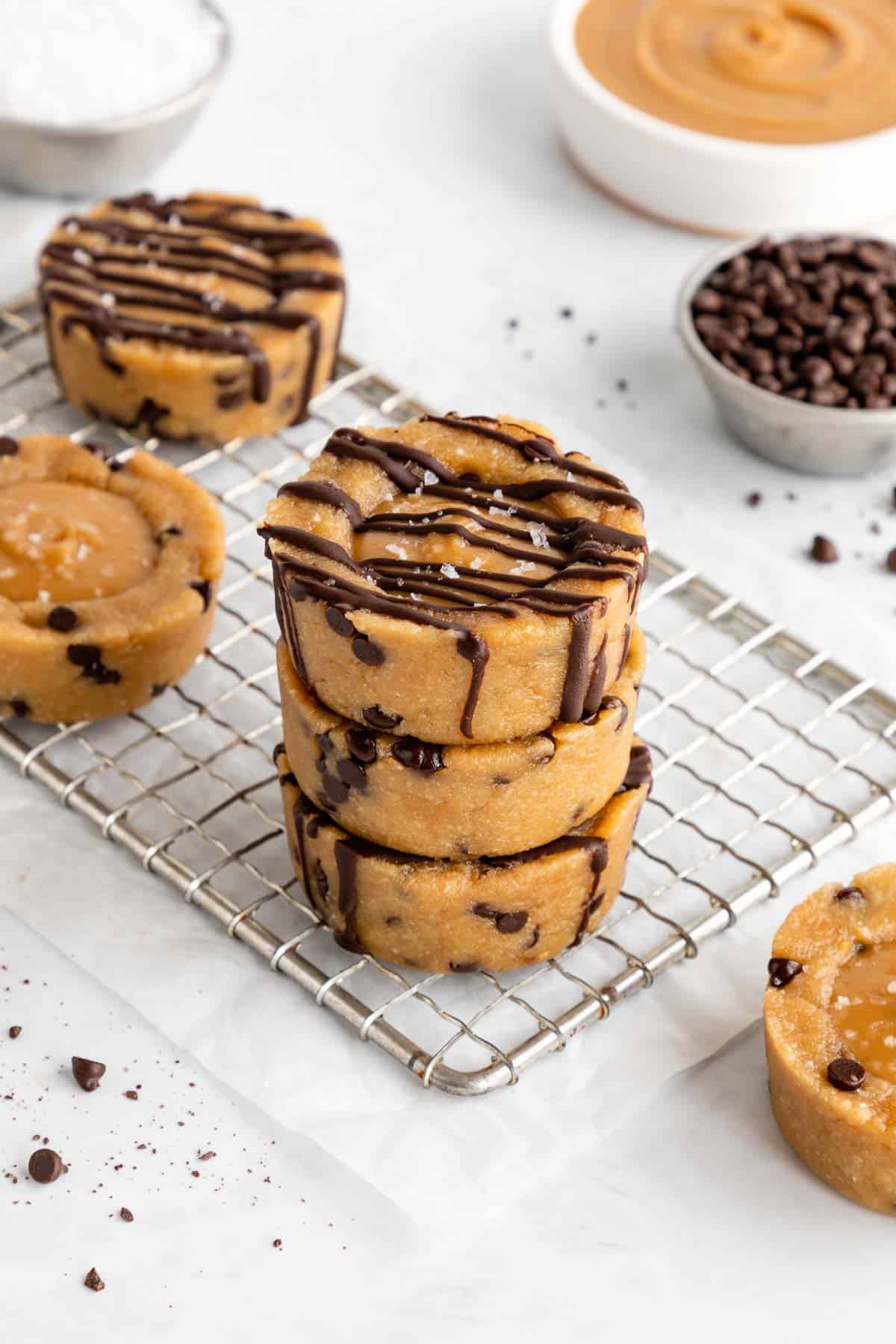 a stack of three vegan caramel cookie dough cups