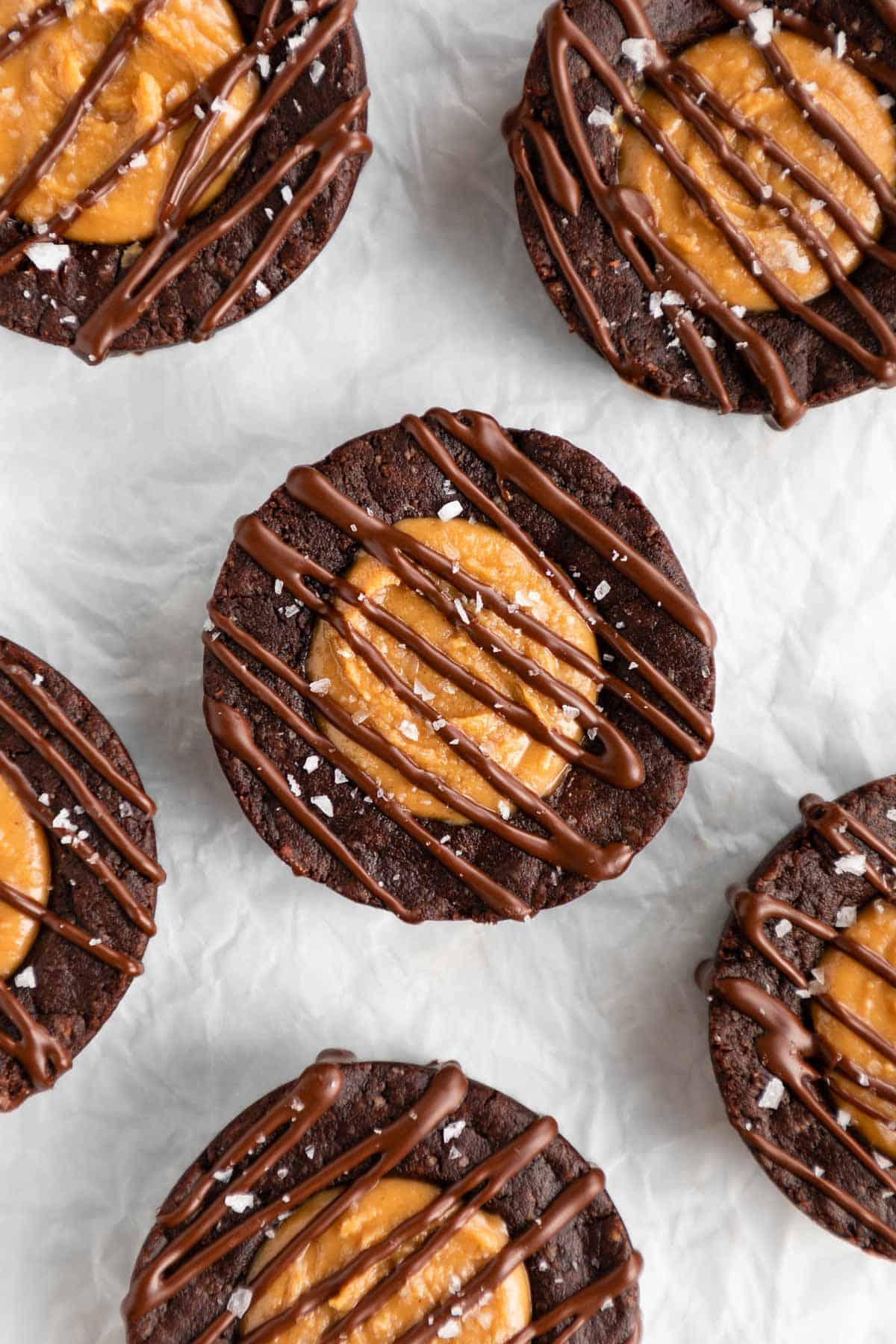 vegan peanut butter brownie cups on white parchment paper