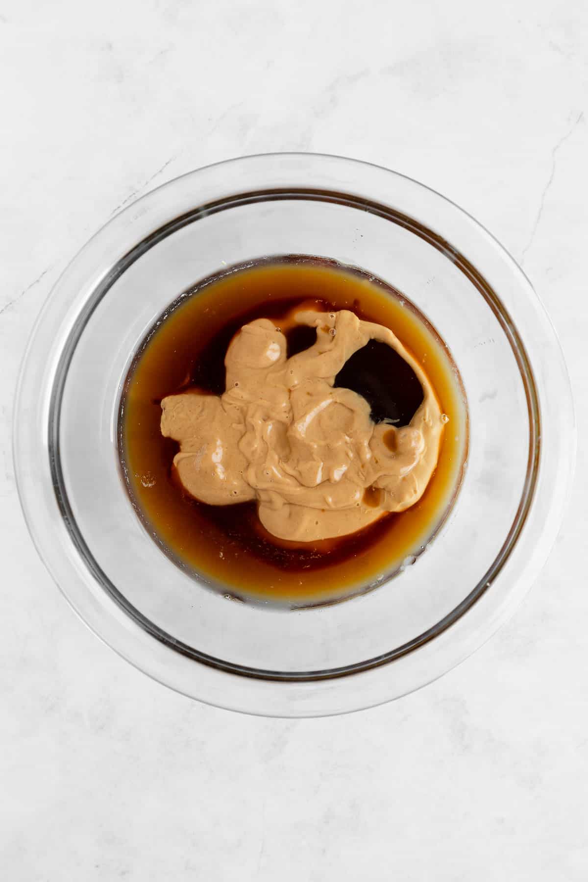 peanut butter, maple syrup, and coconut oil in a glass mixing bowl