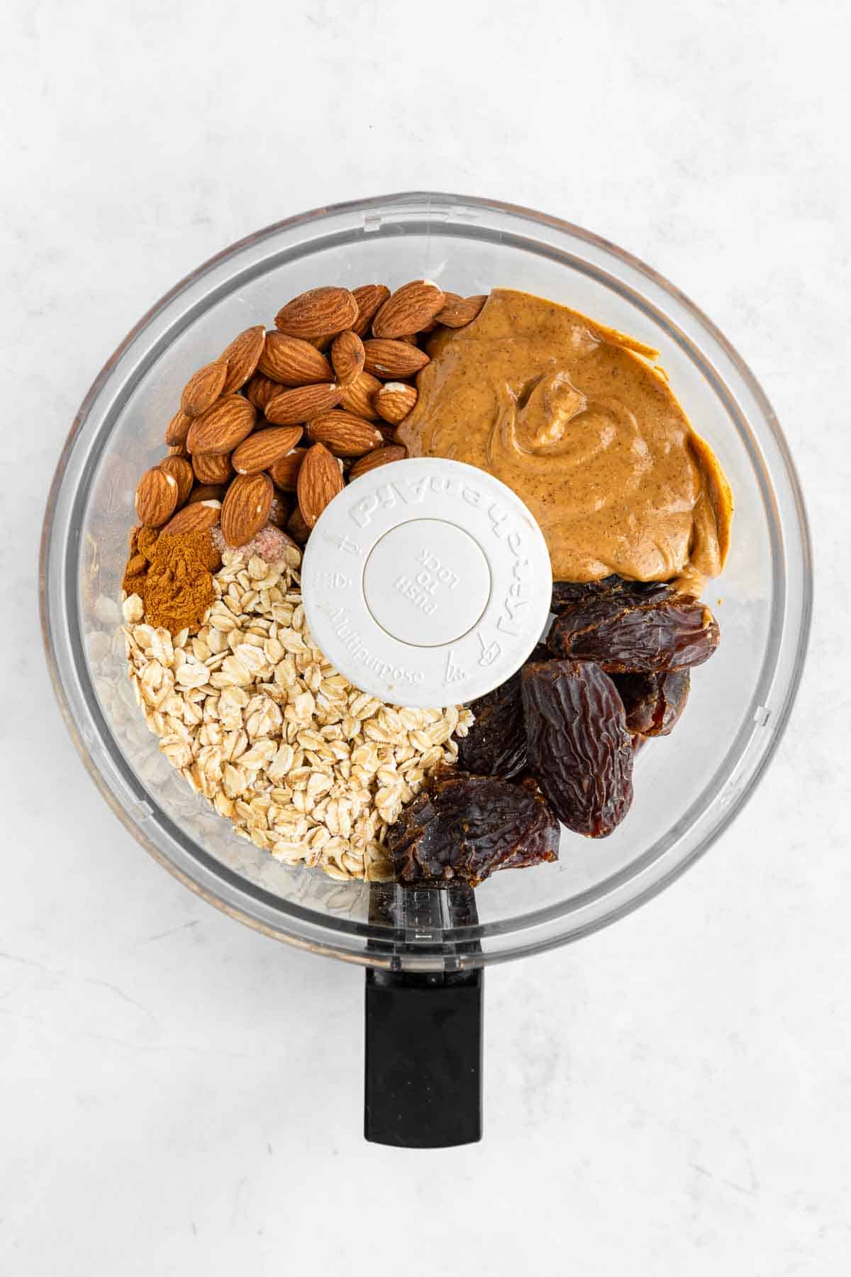 nut butter, dates, oats, and almonds in a food processor