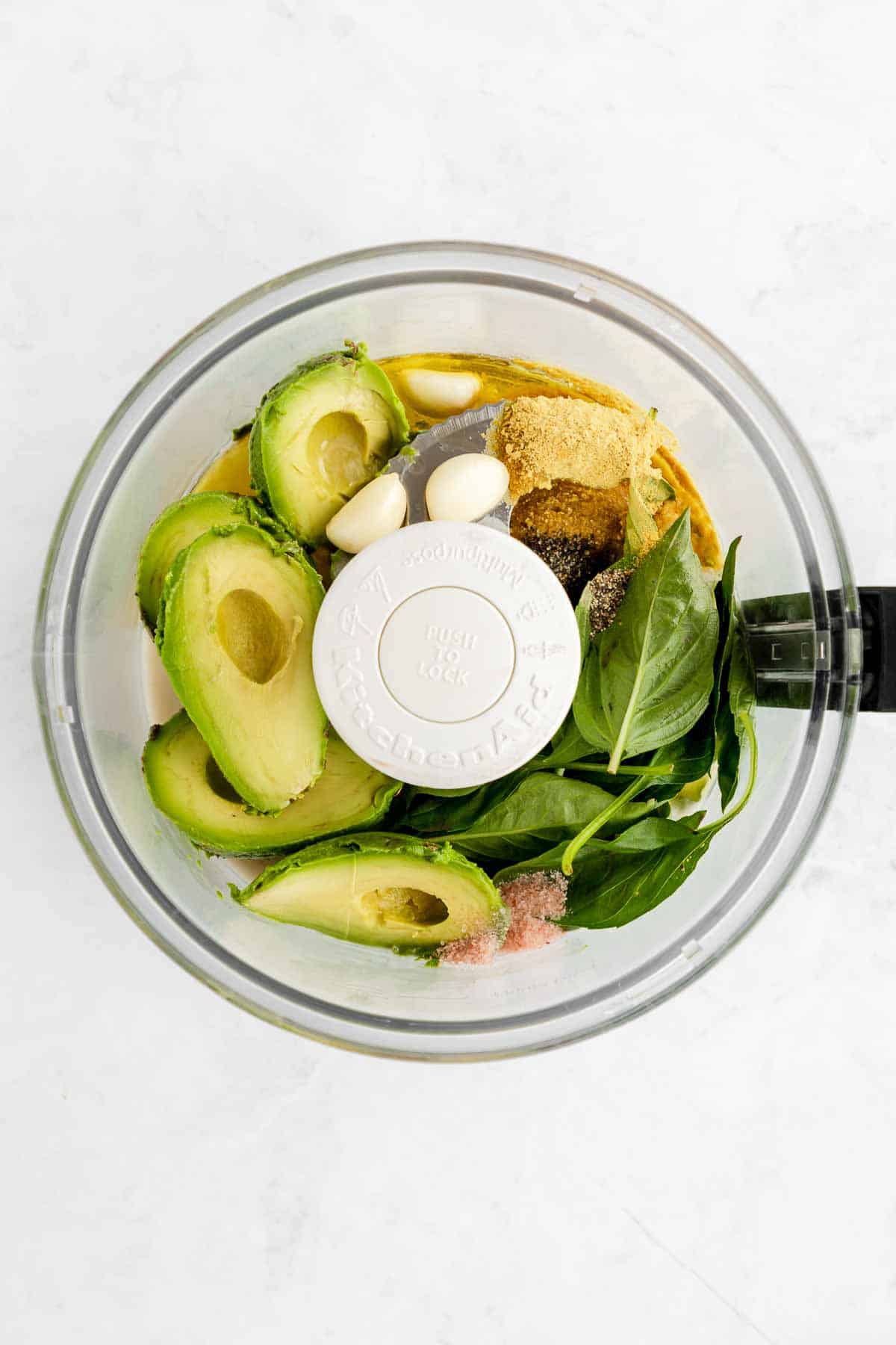 avocados, basil, nutritional yeast, garlic, and olive oil in a food processor