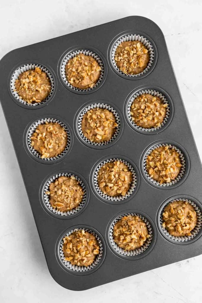 unbaked muffin batter inside a muffin tin