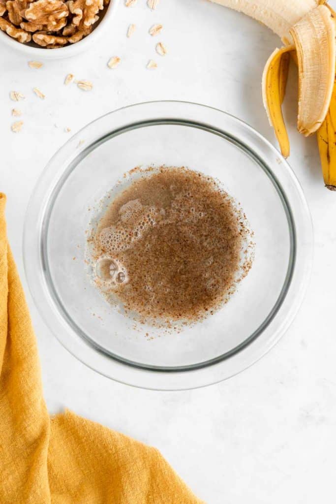 ground flaxseed and water in a glass mixing bowl