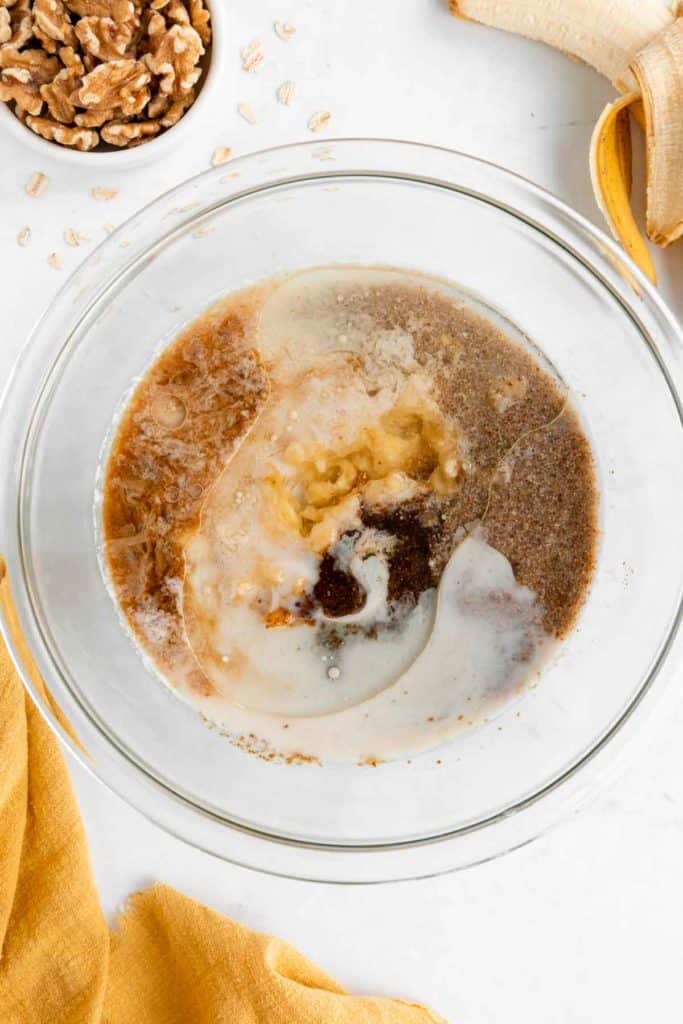 mashed banana, almond milk, flax egg, vanilla, and coconut sugar in a glass bowl