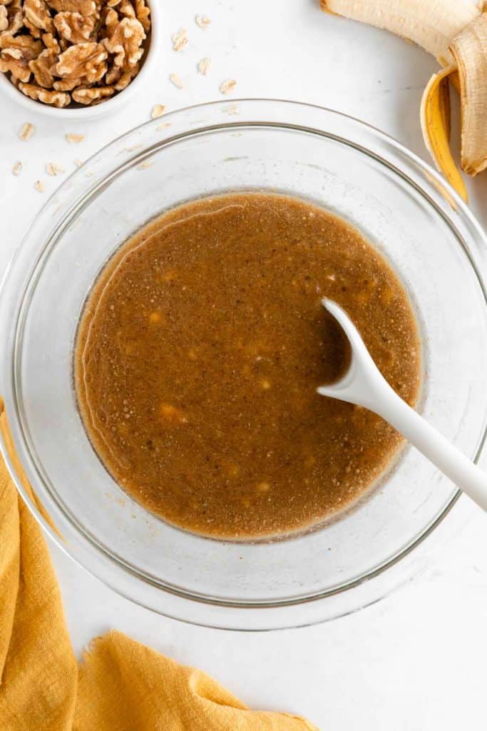 mixing wet ingredients for healthy banana nut muffins