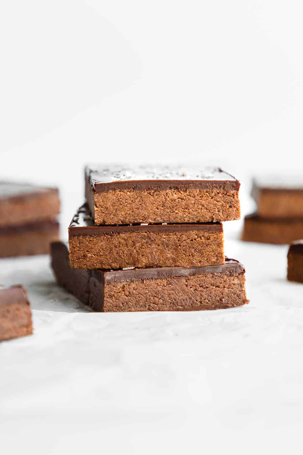 three no bake chocolate protein bars stacked on top of each other