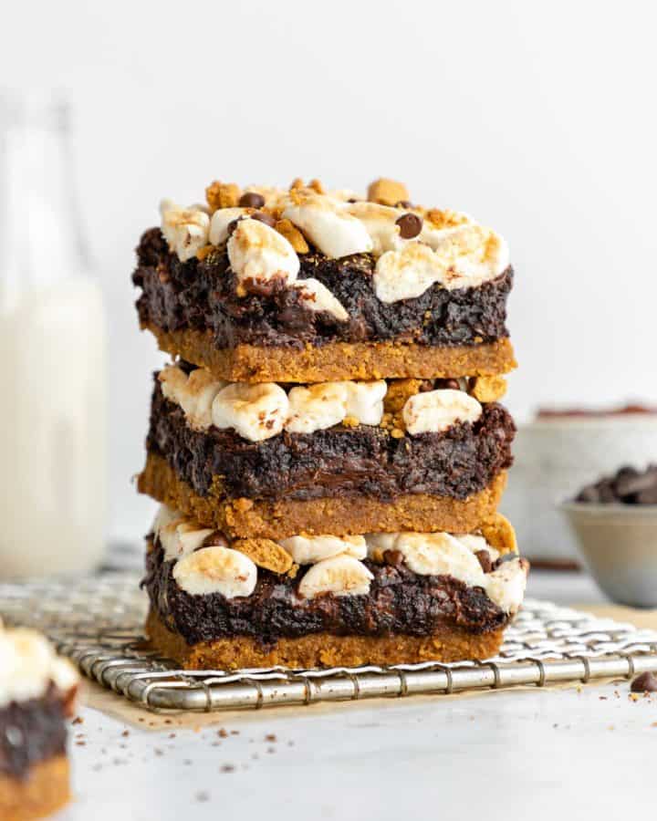 a stack of three vegan s'mores brownies on a wire cooling rack