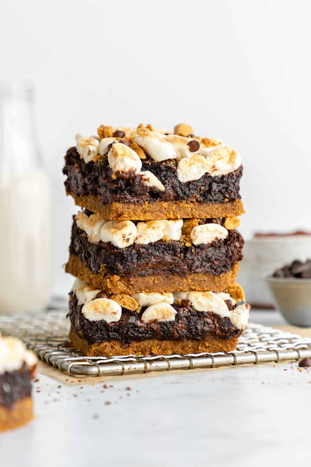 a stack of three vegan s'mores brownies on a wire cooling rack