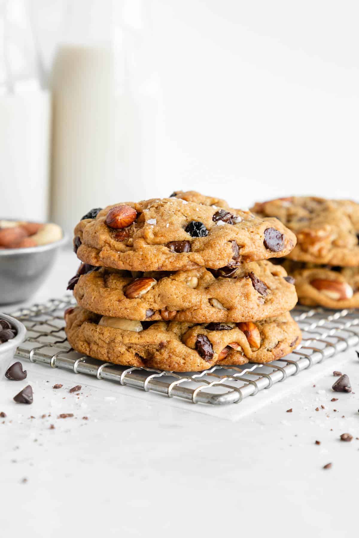 a stack of vegan trail mix cookies with chocolate chips, mixed nuts, and dried fruit