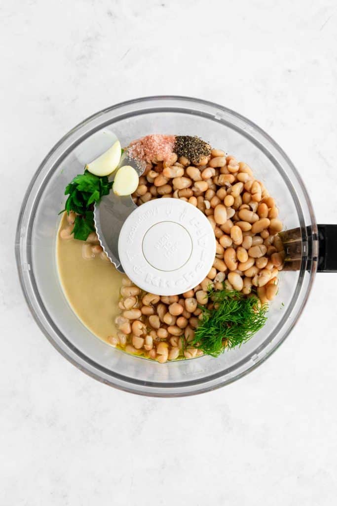 cannellini beans, tahini, olive oil, dill, garlic, parsley, and salt inside a food processor