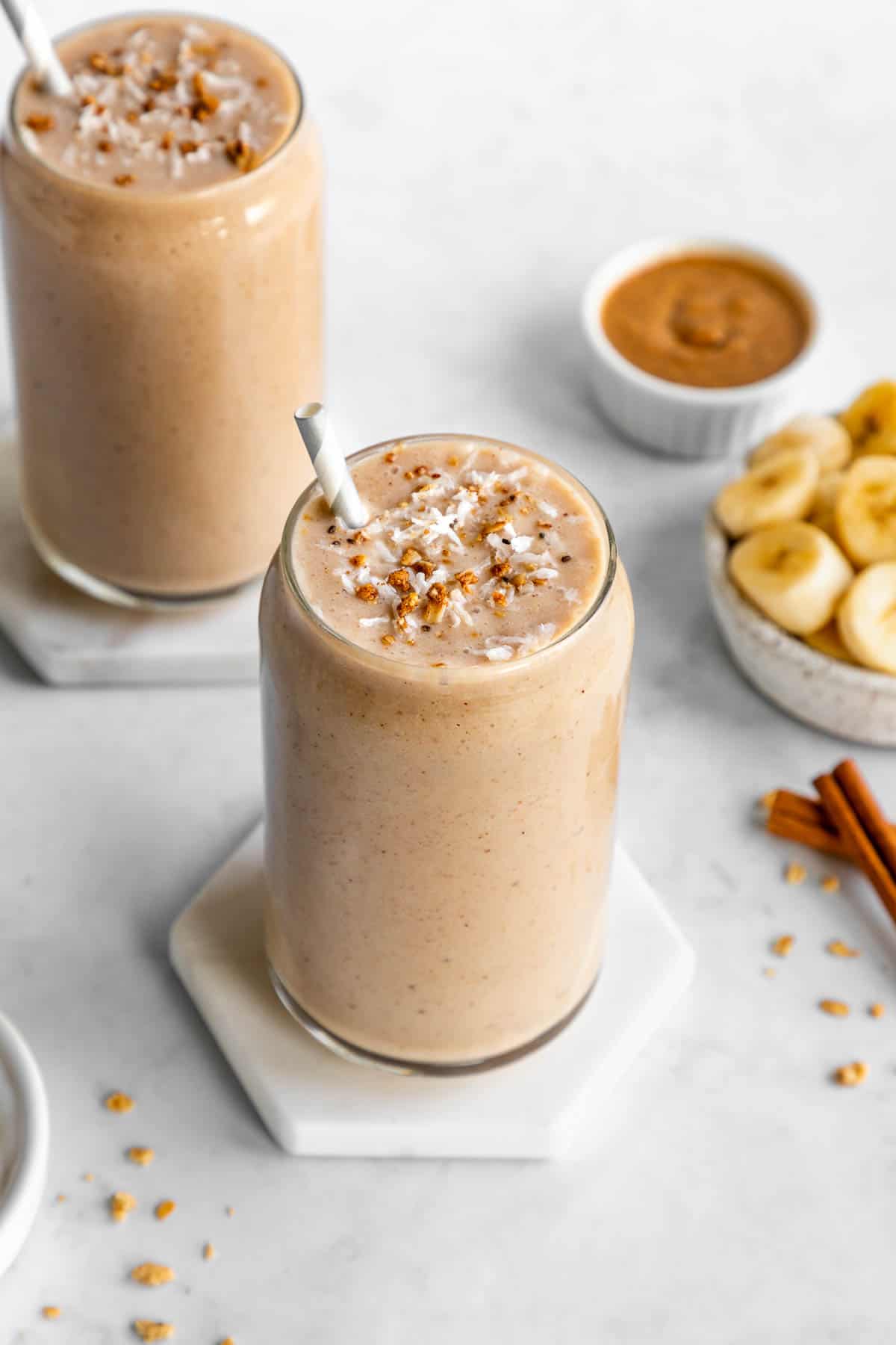 a banana almond butter smoothie inside a glass