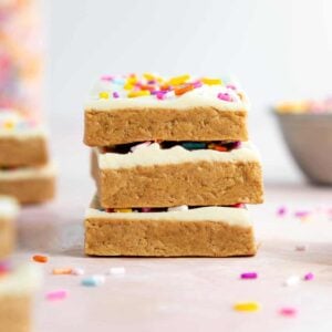 a stack of vegan birthday cake protein bars with sprinkles