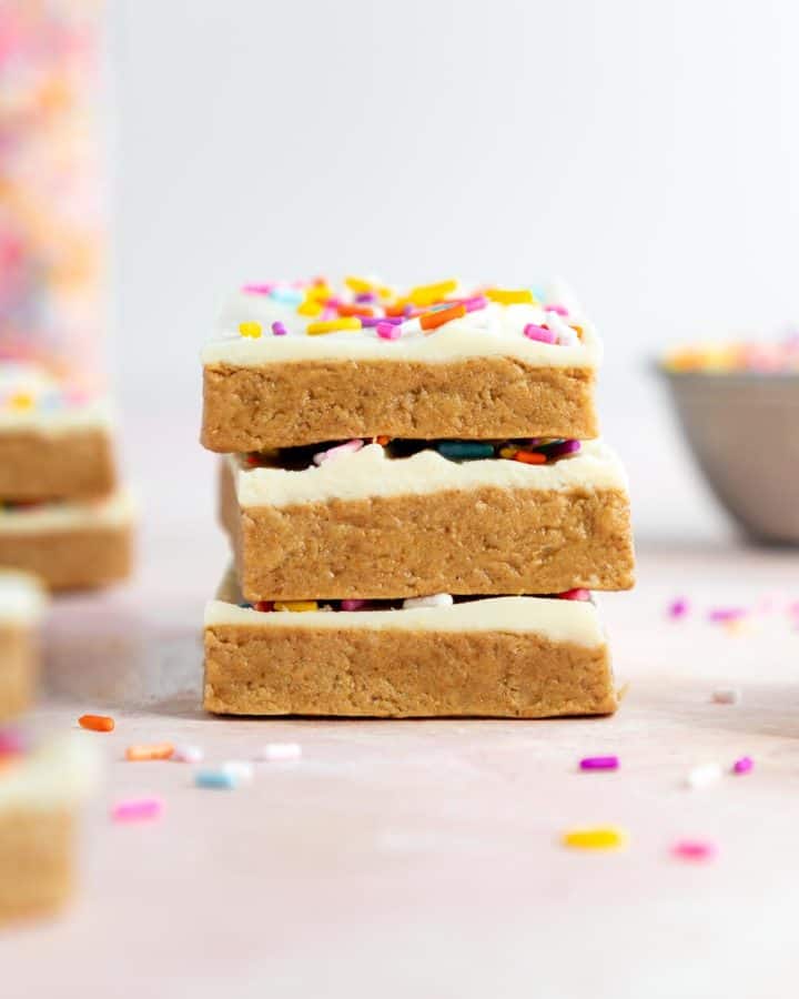a stack of vegan birthday cake protein bars with sprinkles