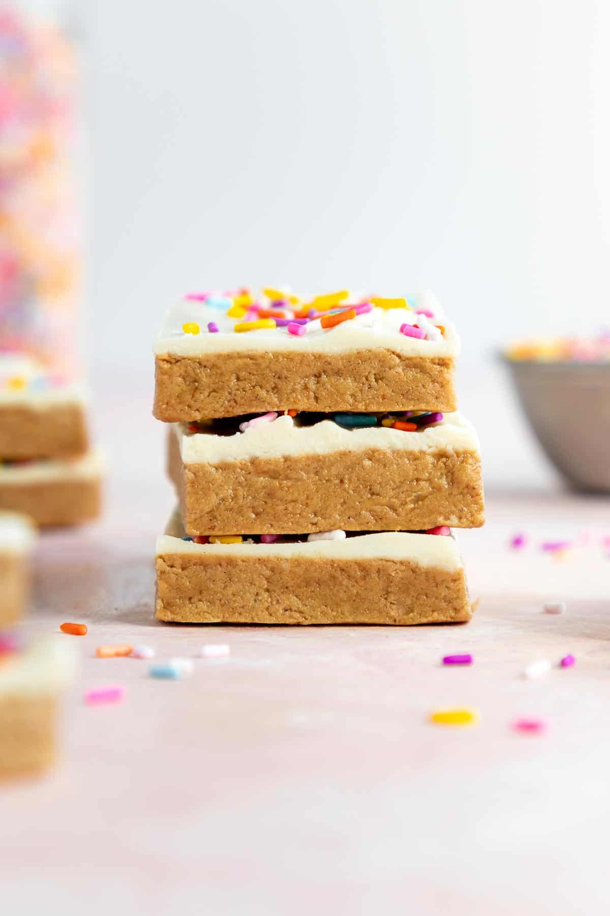 a stack of vegan birthday cake protein bars with sprinkles