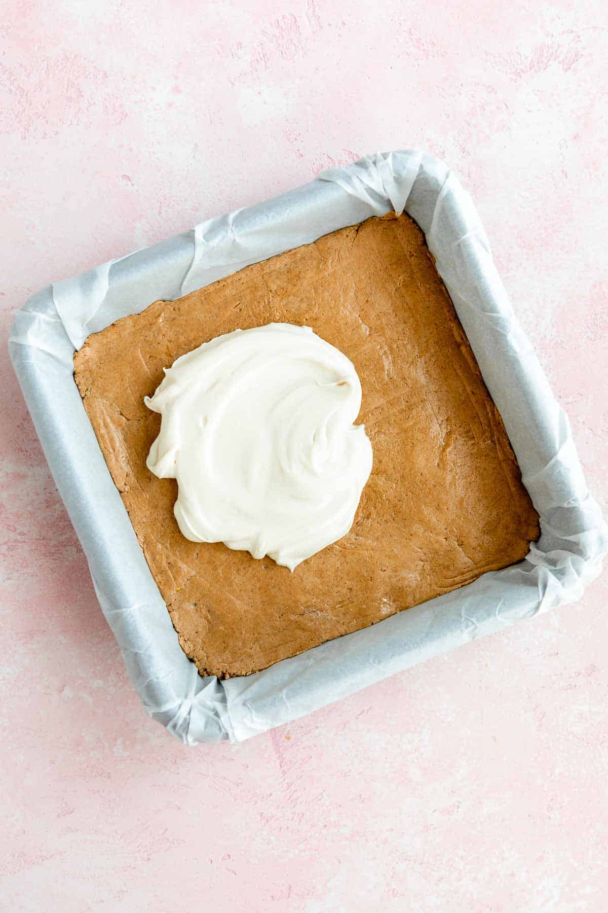 vegan protein bars dough with white chocolate on top inside a baking dish