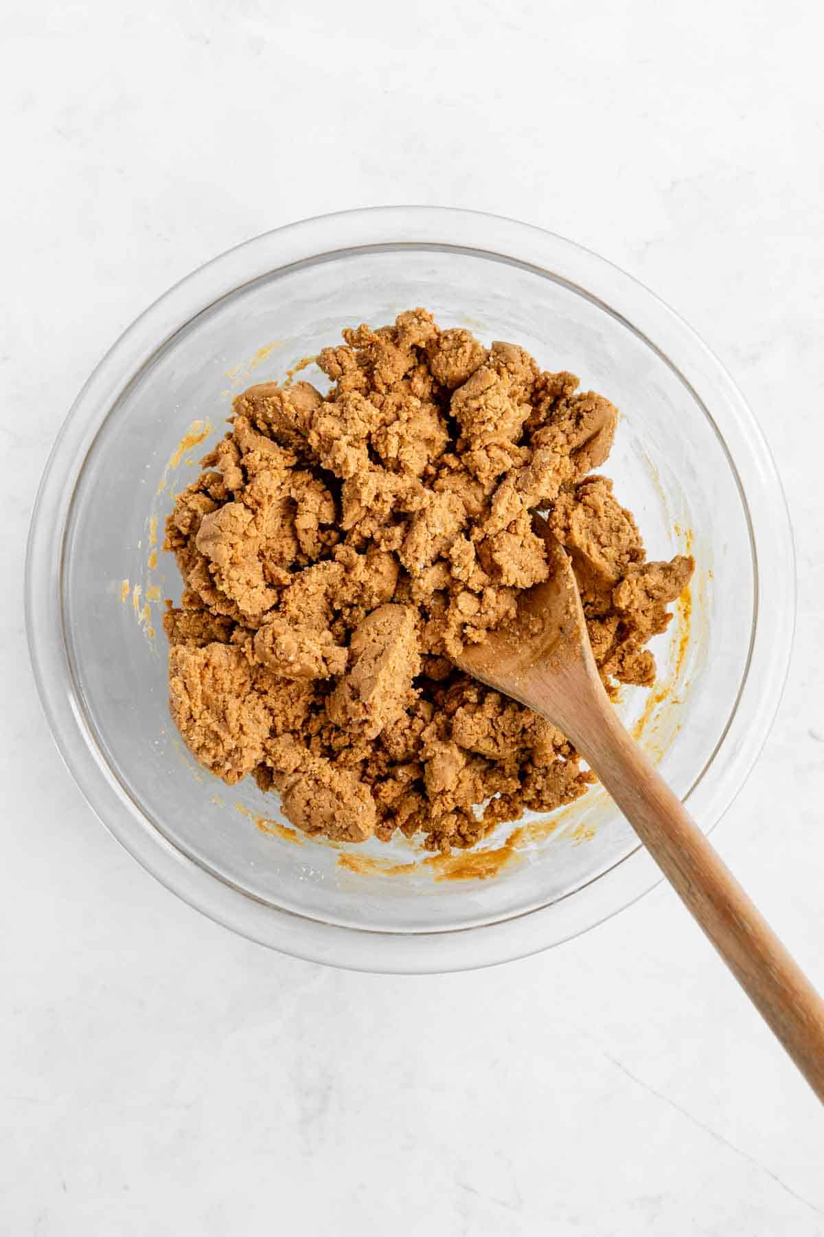 mixing peanut butter protein bar dough in a glass bowl