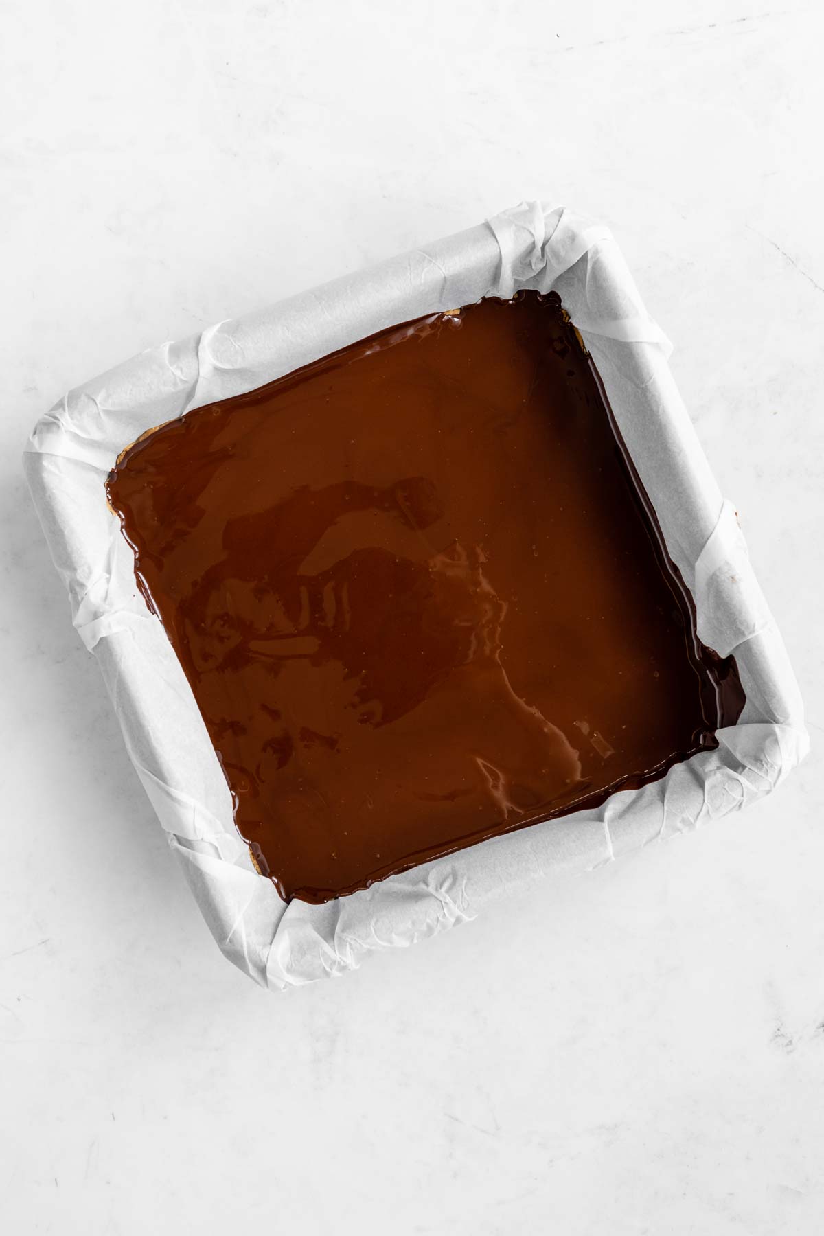 melted chocolate spread across a square baking dish