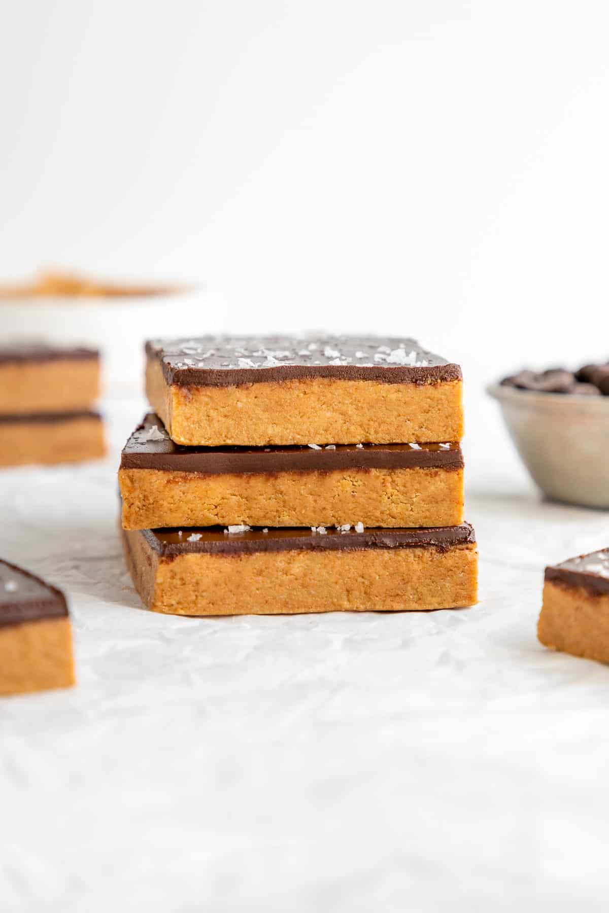 three no bake chocolate peanut butter protein bars stacked on top of each other