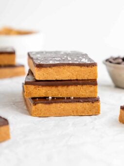 a stack of three homemade chocolate peanut butter protein bars