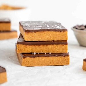 a stack of three homemade chocolate peanut butter protein bars