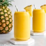 two pineapple coconut smoothies in glasses