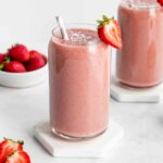 two strawberry banana smoothies inside glasses