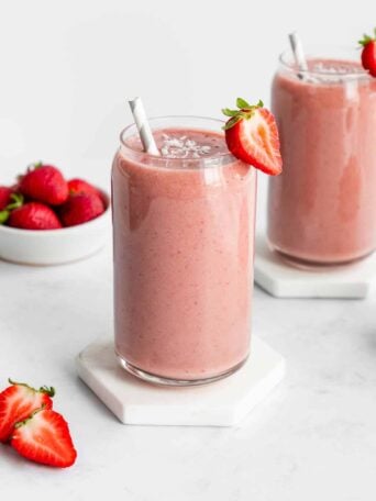 two strawberry banana smoothies inside glasses