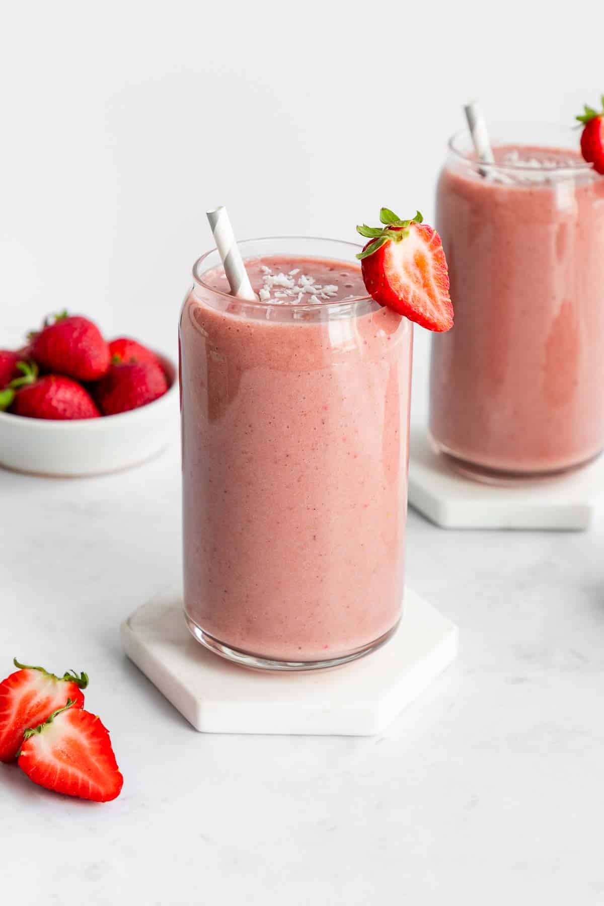 two strawberry banana smoothies inside glasses