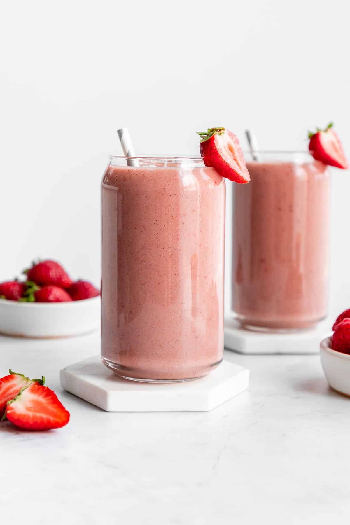 strawberry banana smoothie inside two glasses