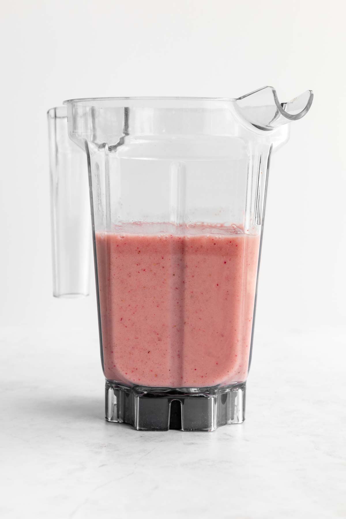 a blended strawberry smoothie inside a vitamix