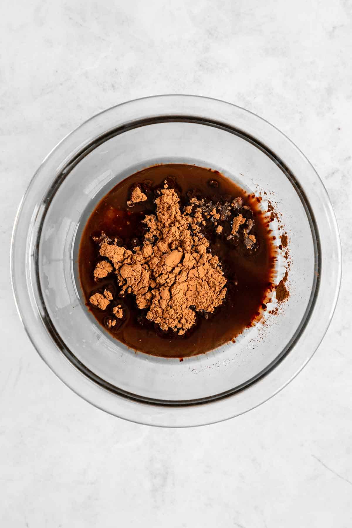 cacao powder, coconut oil, and maple syrup in a glass bowl