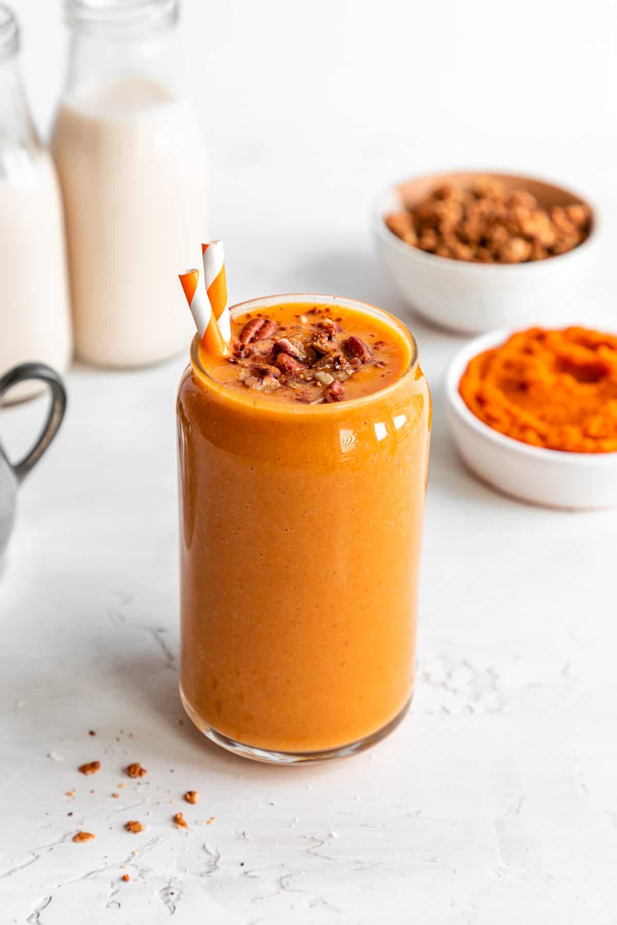 a vegan pumpkin pie smoothie in a glass with granola