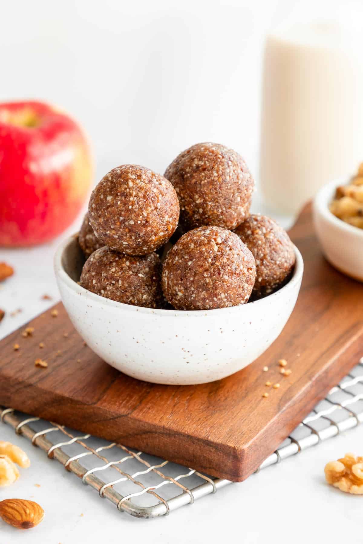 a stack of apple pie energy balls inside a small ceramic bowl