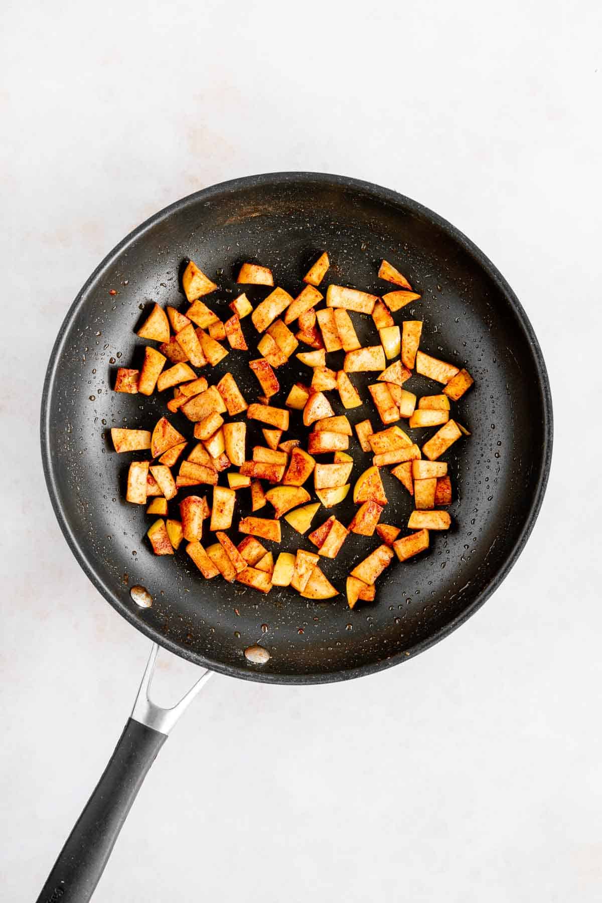 caramelized apples with cinnamon on a skillet