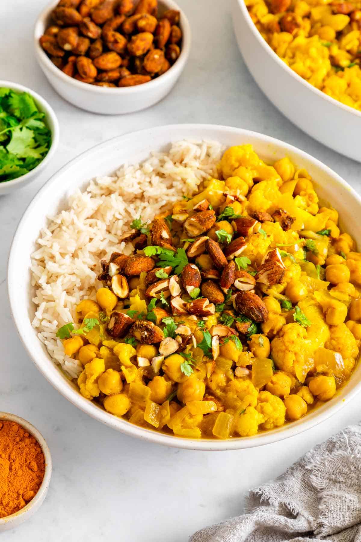 white rice and turmeric curry with chickpeas and cauliflower in a bowl