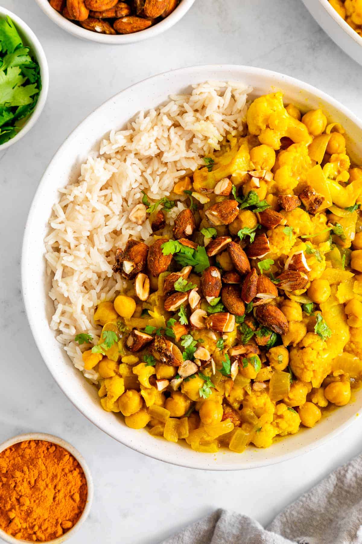 white rice and turmeric curry with chickpeas and cauliflower in a bowl